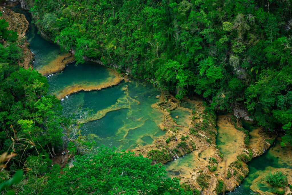 Lush tropical landscape with river and forest in Lanqúin, Guatemala.